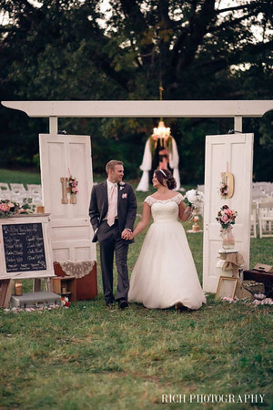 The Wooded White Arbor with its mounted wooden doors beneath the trees