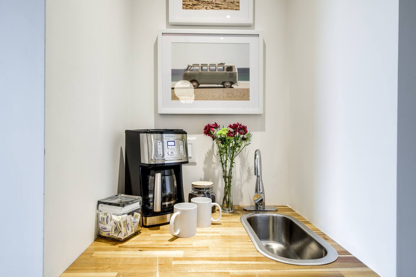 Welcome to the coffee station.  This is a bar sink with two coffee makers.  Both espresso pods and brewed coffee.