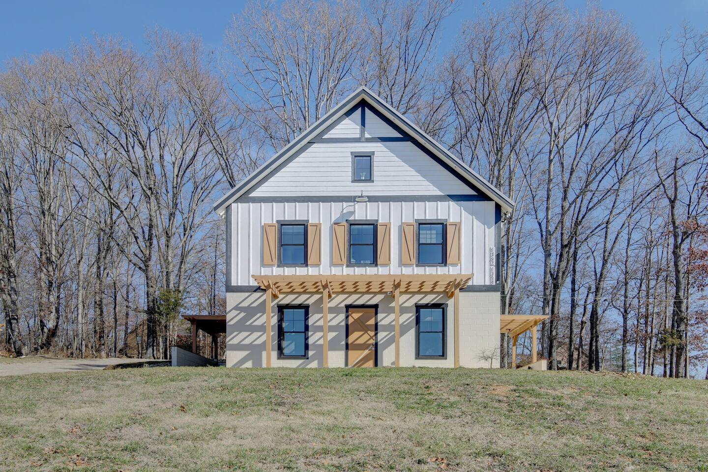 Charming modern farmhouse with wooded privacy and stylish curb appeal