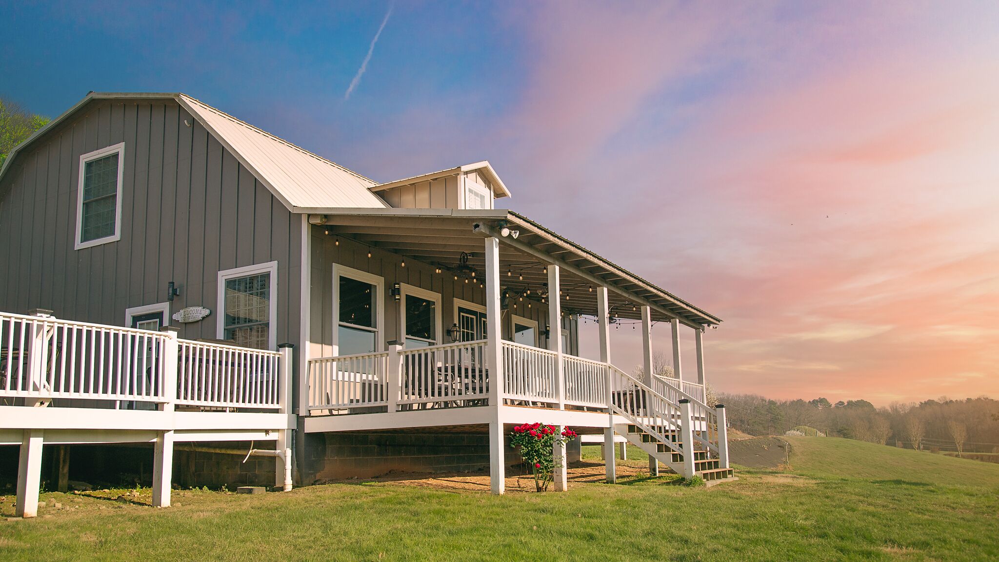 Relax on the wraparound porch with sweeping countryside sunset views
